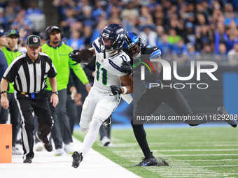 DETROIT,MICHIGAN-September 30: Seattle Seahawks wide receiver Jaxon Smith-Njigba (11) runs the ball against Detroit Lions cornerback Amik Ro...