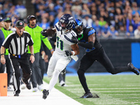 DETROIT,MICHIGAN-September 30: Seattle Seahawks wide receiver Jaxon Smith-Njigba (11) runs the ball against Detroit Lions cornerback Amik Ro...