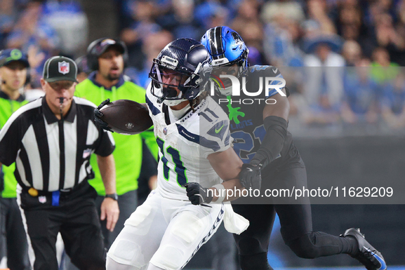 DETROIT,MICHIGAN-September 30: Seattle Seahawks wide receiver Jaxon Smith-Njigba (11) runs the ball against Detroit Lions cornerback Amik Ro...