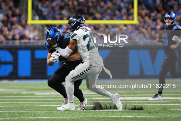 DETROIT,MICHIGAN-September 30: Detroit Lions tight end Brock Wright (89) is tackled by Seattle Seahawks safety Julian Love (20) during the f...