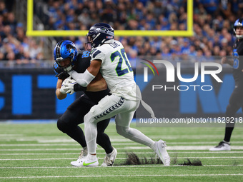 DETROIT,MICHIGAN-September 30: Detroit Lions tight end Brock Wright (89) is tackled by Seattle Seahawks safety Julian Love (20) during the f...