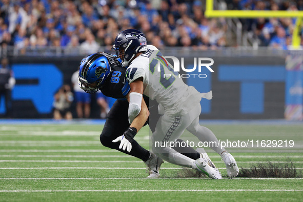 DETROIT,MICHIGAN-September 30: Detroit Lions tight end Brock Wright (89) is tackled by Seattle Seahawks safety Julian Love (20) during the f...