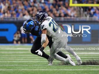 DETROIT,MICHIGAN-September 30: Detroit Lions tight end Brock Wright (89) is tackled by Seattle Seahawks safety Julian Love (20) during the f...