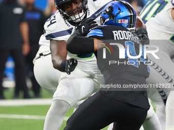 DETROIT,MICHIGAN-September 30: Seattle Seahawks guard Christian Haynes (64) defends against Detroit Lions linebacker Malcolm Rodriguez (44)...