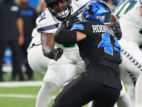 DETROIT,MICHIGAN-September 30: Seattle Seahawks guard Christian Haynes (64) defends against Detroit Lions linebacker Malcolm Rodriguez (44)...