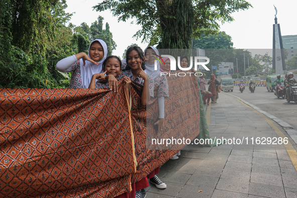 Several students and Bogor residents spread a 4-kilometer-long batik cloth along the pedestrian path, on October 2, 2024. UNESCO designated...