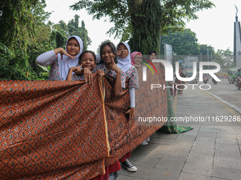 Several students and Bogor residents spread a 4-kilometer-long batik cloth along the pedestrian path, on October 2, 2024. UNESCO designated...