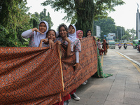 Several students and Bogor residents spread a 4-kilometer-long batik cloth along the pedestrian path, on October 2, 2024. UNESCO designated...