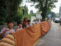 Several students and Bogor residents spread a 4-kilometer-long batik cloth along the pedestrian path, on October 2, 2024. UNESCO designated...