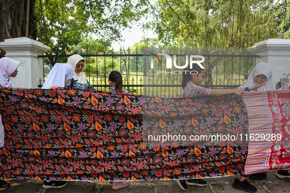 Several students and Bogor residents spread a 4-kilometer-long batik cloth along the pedestrian path, on October 2, 2024. UNESCO designated...