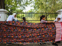 Several students and Bogor residents spread a 4-kilometer-long batik cloth along the pedestrian path, on October 2, 2024. UNESCO designated...