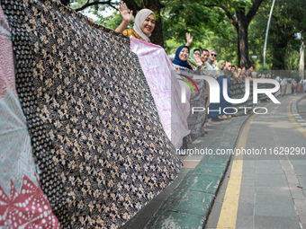 Several students and Bogor residents spread a 4-kilometer-long batik cloth along the pedestrian path, on October 2, 2024. UNESCO designated...