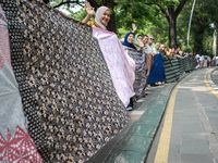 Several students and Bogor residents spread a 4-kilometer-long batik cloth along the pedestrian path, on October 2, 2024. UNESCO designated...