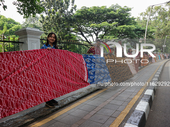 Several students and Bogor residents spread a 4-kilometer-long batik cloth along the pedestrian path, on October 2, 2024. UNESCO designated...