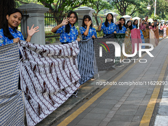 Several students and Bogor residents spread a 4-kilometer-long batik cloth along the pedestrian path, on October 2, 2024. UNESCO designated...