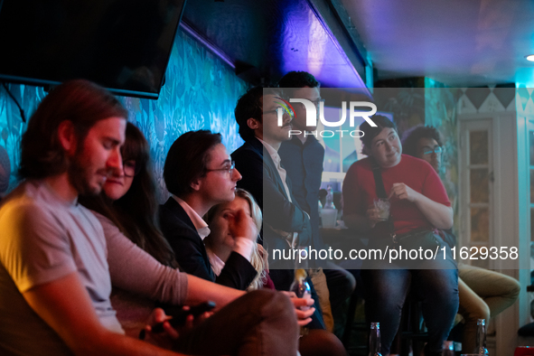 People attend a watch party at Madhatter for the vice presidential debate between Demcocrat Gov. Tim Walz (D-MN) and Republican Sen. J.D. Va...