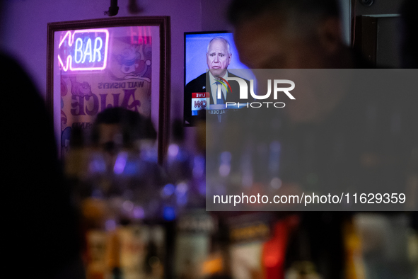 A bartender mixes drinks as the vice presidential debate plays on a television behind him in Washington, DC, on October 1, 2024.  Madhatter...