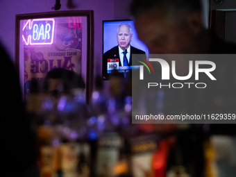 A bartender mixes drinks as the vice presidential debate plays on a television behind him in Washington, DC, on October 1, 2024.  Madhatter...