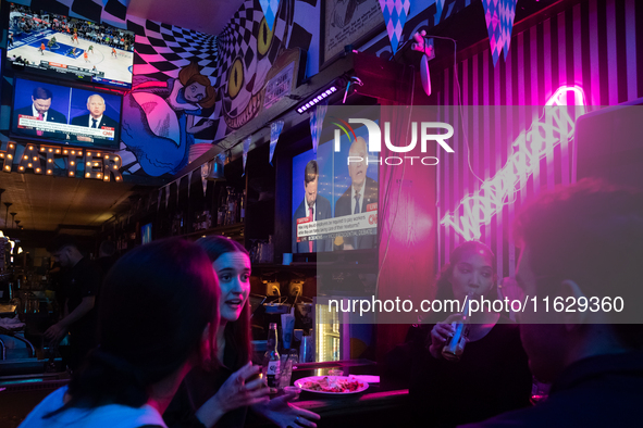 People attend a watch party at Madhatter for the Vice presidential debate between Demcocrat Gov. Tim Walz (D-MN) and Republican Sen. J.D. Va...