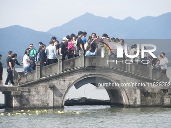 A large number of tourists visit the West Lake in Hangzhou, China, on October 2, 2024. (