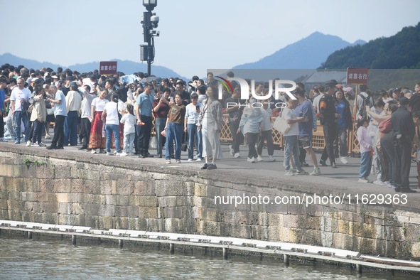 A large number of tourists visit the West Lake in Hangzhou, China, on October 2, 2024. 