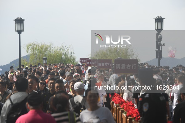 A large number of tourists visit the West Lake in Hangzhou, China, on October 2, 2024. 