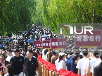 A large number of tourists visit the West Lake in Hangzhou, China, on October 2, 2024. (