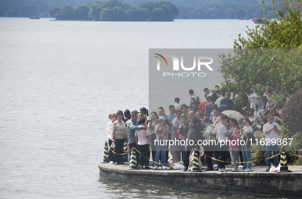 A large number of tourists visit the West Lake in Hangzhou, China, on October 2, 2024. 