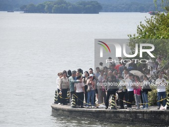 A large number of tourists visit the West Lake in Hangzhou, China, on October 2, 2024. (