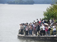 A large number of tourists visit the West Lake in Hangzhou, China, on October 2, 2024. (