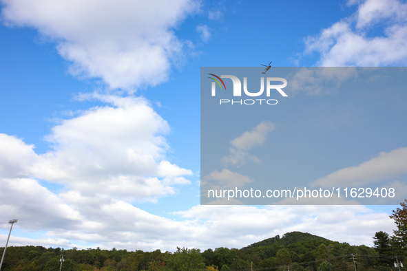 A U.S. Navy helicopter surveys damage from Hurricane Helene over Asheville, North Carolina on October 1, 2024. 