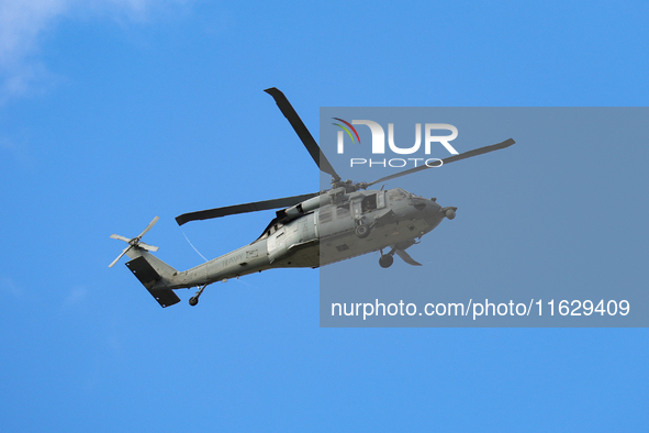 A U.S. Navy helicopter surveys damage from Hurricane Helene over Asheville, North Carolina on October 1, 2024. 