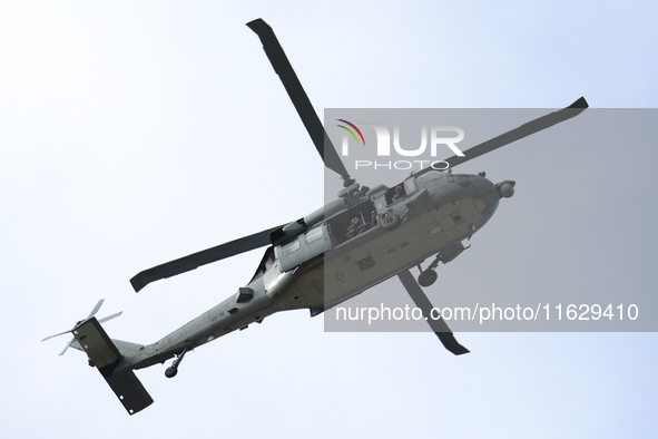 A U.S. Navy helicopter surveys damage from Hurricane Helene over Asheville, North Carolina on October 1, 2024. 