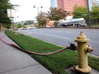 A fire hydrant is connected to a hose near Mission Hospital in Asheville, North Carolina on October 1, 2024. (