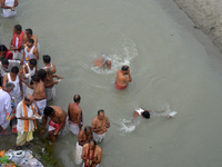 Hindu devotees perform the 'Tarpan' ritual to pay obeisance to their forefathers on the last day of 'Pitru Paksha' on the banks of the Mahan...