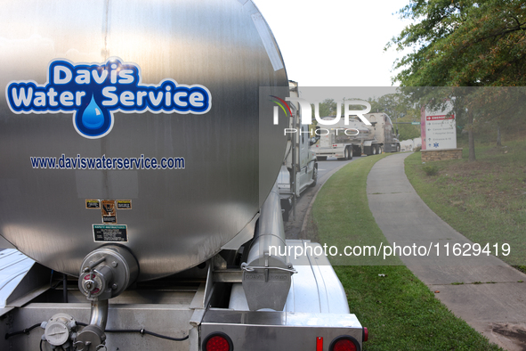 Water supply vehicles park near Mission Hospital in Asheville, North Carolina on October 1, 2024. 