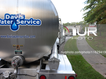 Water supply vehicles park near Mission Hospital in Asheville, North Carolina on October 1, 2024. (