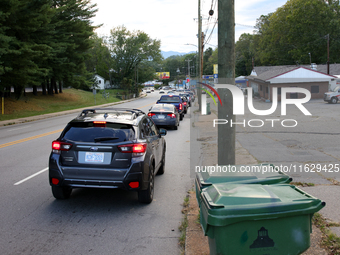 Vehicles wait in line for gasoline in Asheville, North Carolina on October 1, 2024 after Hurricane Helene caused widespread damage, cutting...