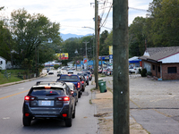 Vehicles wait in line for gasoline in Asheville, North Carolina on October 1, 2024 after Hurricane Helene caused widespread damage, cutting...