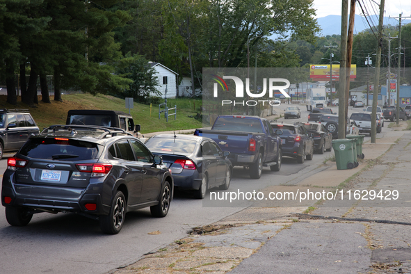 Vehicles wait in line for gasoline in Asheville, North Carolina on October 1, 2024 after Hurricane Helene caused widespread damage, cutting...