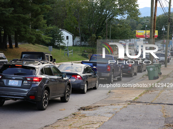 Vehicles wait in line for gasoline in Asheville, North Carolina on October 1, 2024 after Hurricane Helene caused widespread damage, cutting...