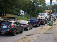 Vehicles wait in line for gasoline in Asheville, North Carolina on October 1, 2024 after Hurricane Helene caused widespread damage, cutting...