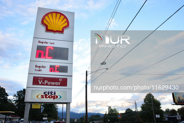 A gas station price sign in Asheville, North Carolina displays the initials of the state on October 1, 2024 after Hurricane Helene caused wi...