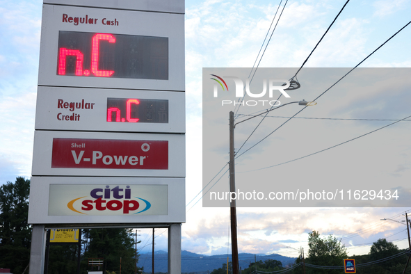 A gas station price sign in Asheville, North Carolina displays the initials of the state on October 1, 2024 after Hurricane Helene caused wi...