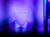 Minnesota Gov. Time Walz (D) appears on a large screen during the vice presidential debate, under the pink and purple lights at Madhatter in...