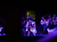 People react to the vice presidential debate during a watch party at under the pink and purple lights at Madhatter in Washington, DC, on Oct...