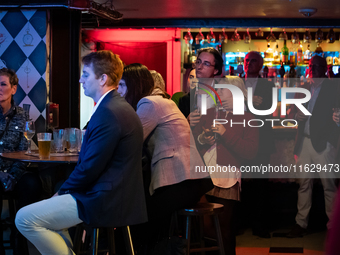 People attend a watch party at Madhatter for the Vice presidential debate between Demcocrat Gov. Tim Walz (D-MN) and Republican Sen. J.D. Va...