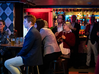 People attend a watch party at Madhatter for the Vice presidential debate between Demcocrat Gov. Tim Walz (D-MN) and Republican Sen. J.D. Va...