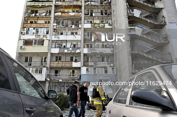 Men walk past the residential building damaged by Russian shelling in Zaporizhzhia, Ukraine, on October 1, 2024. NO USE RUSSIA. NO USE BELAR...