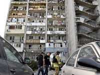 Men walk past the residential building damaged by Russian shelling in Zaporizhzhia, Ukraine, on October 1, 2024. NO USE RUSSIA. NO USE BELAR...